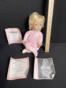 lot 223 image: Vintage Vinyl Baby Doll - Pink Nightgown with Certificate of Authenticity & Photo Card