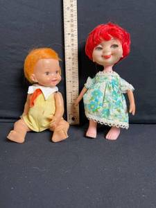 lot 247 image: Two Vintage Vinyl Dolls - Red-Haired Floral Dress Doll & Orange-Haired Yellow Romper Doll