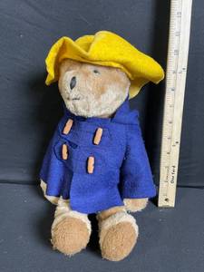 lot 258 image: Teddy Bear Plush With Blue Coat And Yellow Hat - 9-11 Inches Tall