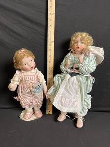 lot 262 image: Pair of Vintage Bisque Dolls in Period Dresses - Green Stripe Dress & Pink Stripe Outfit