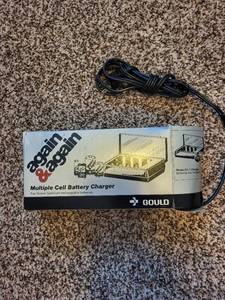 lot 325 image: Gould Again & Again Multiple Cell Battery Charger with 4 D-Size Batteries