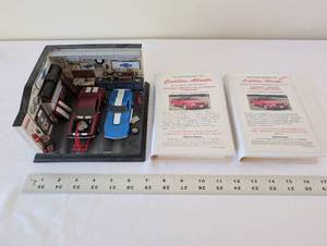 lot 23 image: Danbury Mint The Speed Shop Diorama with Cadillac Allante Story Tape Sets