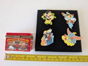 lot 121 image: Barnums Animals Crackers Trinket Box and Set of 4 Disney Pins