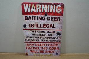 lot 98 image: Novelty Metal Sign - Baiting Deer is Illegal