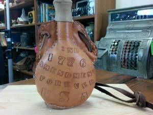 lot 143 image: Unique Leather Encased Flask with Leather Strap � 1776 USA