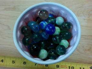 lot 144 image: Cup chock full of Vintage Cats Eye Marbles