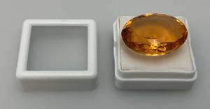 lot 78 image: 28.10 Lab Created Orange Topaz Oval Cut Loose Gemstone In Protective Case