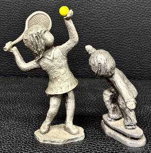 lot 36H image: Hudson Pewter Walli Ortman Tennis and Vintage Walli Ortan Skateboarder Figurines Set