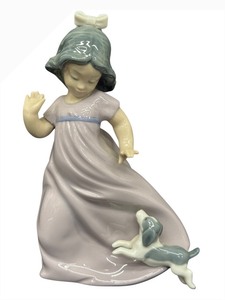 lot 73 image: NAO Porcelain Figurine - Girl in Lavender Dress with Puppy