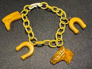 lot 36JT image: Vintage Equestrian Themed Bakelite Charm Bracelet with Horse Head, Horseshoes & Boot Pendants