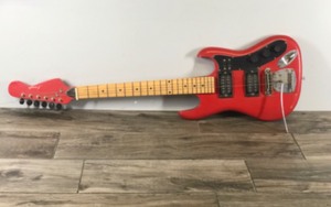 lot 418 image: Red & Black Electric Guitar - Not sure the brand but I believe it says Jennifer on the head of guitar