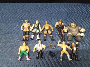 lot 109 image: Vintage wrestling figurines and 2 toy wrestling belts