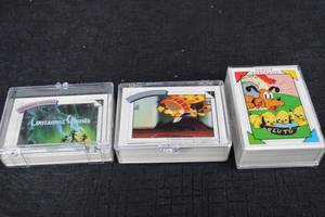 lot 119 image: Disney Lonesome Ghosts Card Decks & Pluto Family Portraits in Clear Cases