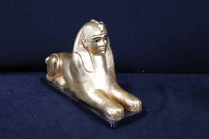lot 94 image: Egyptian Sphinx Statue - Gold-Tone Metal, Lying Pose, 15 in long