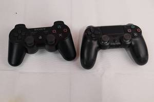 lot 100 image: Sony DualShock 3 Wireless Controller Pair for PS3 - Black