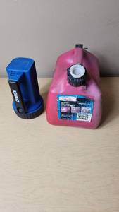 lot 5 image: Dorcy Flashlight and Red Gas Can with Strainer