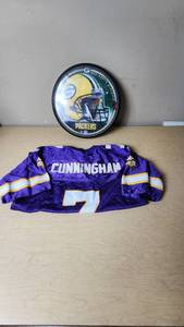 lot 31 image: Minnesota Vikings Randall Cunningham Starter Jersey and Packers Clock