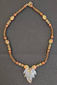 lot 74 image: 20-Inch Beaded Stone Necklace with Carved Leaf Pendant