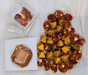 lot 79 image: Collection of Swarovski Crystal Embellishments, Amber Tones