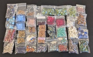 lot 83 image: Lot of 40 Packs Assorted Craft Beads in Various Colors and Shapes