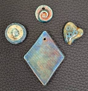 lot 113 image: Set of 4 Handmade Ceramic Pendants Assorted Shapes and Designs