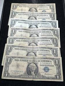 lot 65 image: 7 US BLUE SEAL $1 SILVER CERTIFICATES