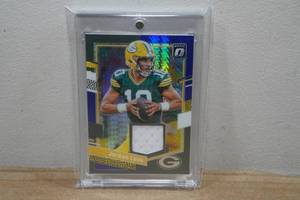 lot 13 image: 2023 Panini Optic Threads Jordan Love Jersey Insert Football Card