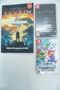 lot 12 image: Nintendo Switch Super Mario Bros. Wonder game & The Elder Scrolls VSkyrim with the Official Companion Guide Book