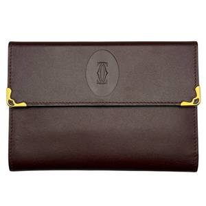 lot 38 image: Cartier Must de Cartier Burgundy Leather Long Wallet with Gold Corner Hardware  Pre-Owned Retail $850