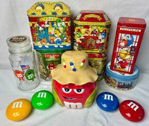 lot 79 image: M & Ms Collection includes Ceramic Jar, 1984 Olympics Commemorative Jar, 6 Tins and 4 Mini Tins