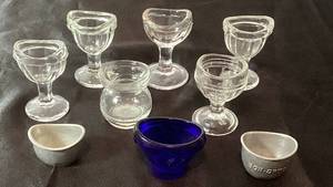 lot 73 image: Collection of Vintage Glass Eye Wash Cups,Cobalt Blue Optrex Cup and Lavoptix & Bon-Opto Aluminum Eye Wash Cups