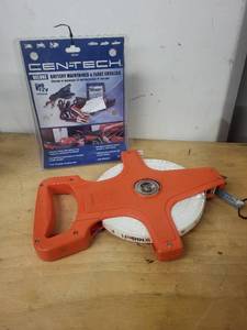 lot 65 image: Cen-Tech Deluxe Battery Maintainer and 50m Fiberglass Tape Measure