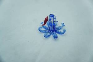 lot 28 image: Hand-Blown Glass Octopus Figurine wSanta Hat. 2 tall