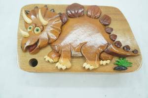 lot 31 image: Handcrafted Wooden Puzzle Box. Triceratops Design. Red Felt Lined