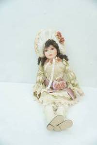 lot 196 image: Porcelain Doll. Sits 17.5 tall
