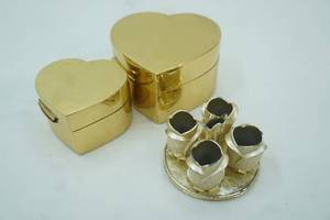 lot 508 image: Lacquered Nesting Heart-Shaped Jewelry Boxes. Gold-Toned Vintage Avon Golden Vanity Roses Lipstick Holder