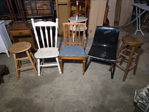 lot 102 image: Lot of Chairs and Stools including White Spindle-Back Chair, Wooden Chair with Blue Cushion, Black Plastic Chair, and Wooden Bar Stool