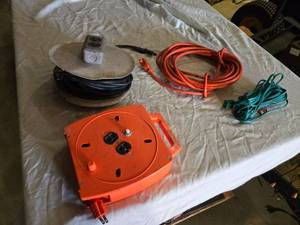 lot 152 image: Orange Extension Cord Reel, Black Cable Reel, and Extension Cords