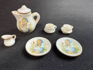 lot 90 image: Miniature Porcelain Tea Set with Hummel Style Girl Artwork