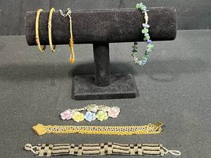 lot 169 image: Assorted Bracelet and Bangle Jewelry Lot with Beaded, Floral, and Chain Designs