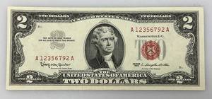 lot 103 image: 2 Dollar Bill From 1963 With Red Seal And Red Numbers (Very Good Condition) In Protective Sleeve)