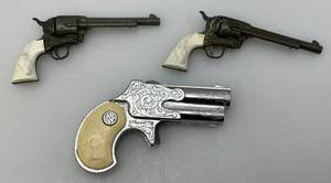 lot 235 image: Misc. Vintage Miniature Cap Guns Two Break Open Pistols With Cow Adorned Handles And One Derringer (Missing Hammer)