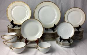 lot 4 image: Limoges France Marshall Fields (M.F. & C.) Chicago Gold Encrusted Porcelain Dinnerware Set with Gold Trimmed Teacups and Saucers from O. & E. G. Royal Austria