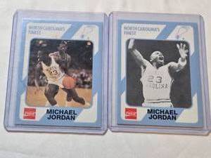 lot 191 image: Lot of 2 Michael Jordan Basketball Cards - North Carolinas Finest Set with Coca-Cola Logo and 1989 Collegiate Collection.