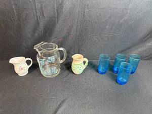 lot 9 image: Mixed Set of Pitchers and Blue Glass Tumblers Including Pfaltzgraff and Nemadji Pottery