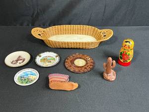 lot 39 image: Collection of Vintage Souvenir Plates, Wicker Basket, Russian Nesting Doll, and Decorative Items