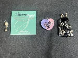 lot 86 image: Assorted Jewelry Lot Including Sterling Silver Pearl Pendant, Heart Glass Pendant, and Black Artisan Pendant