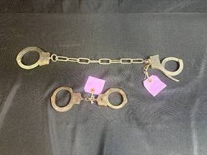 lot 100 image: Vintage Peerless Handcuffs and Chain Set, Springfield Mass.