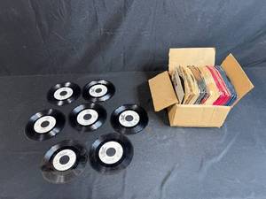 lot 146 image: Vintage 45 RPM Vinyl Record Collection Most with Sleeves in Cardboard Box