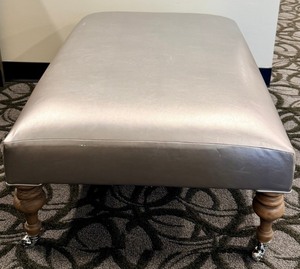 lot 33 image: Gray Faux Leather Ottoman Bench with Turned Wood Legs & Casters